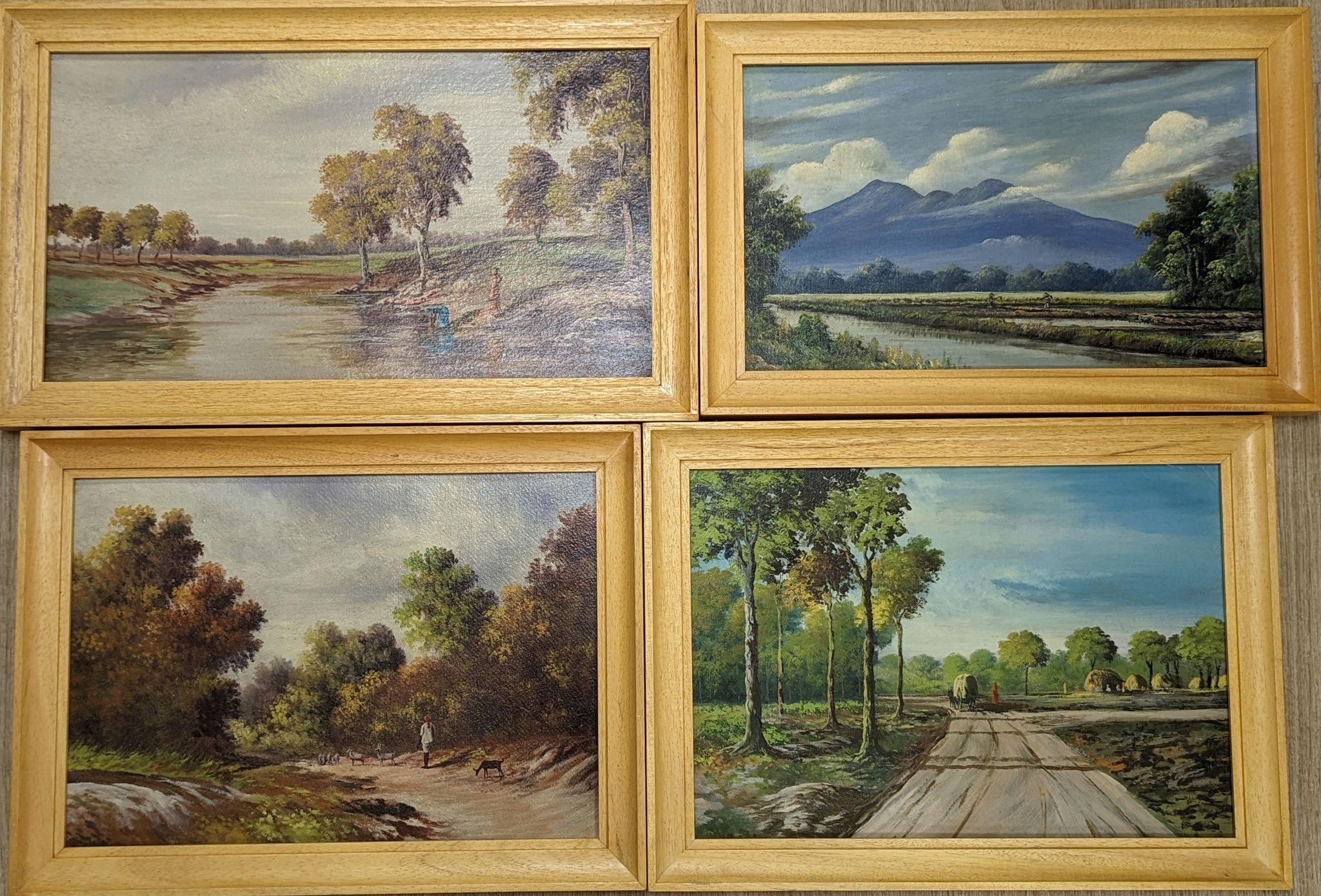 Early 20th century Indian School, four oils on card, Rustic landscapes, largest 31 x 45cm